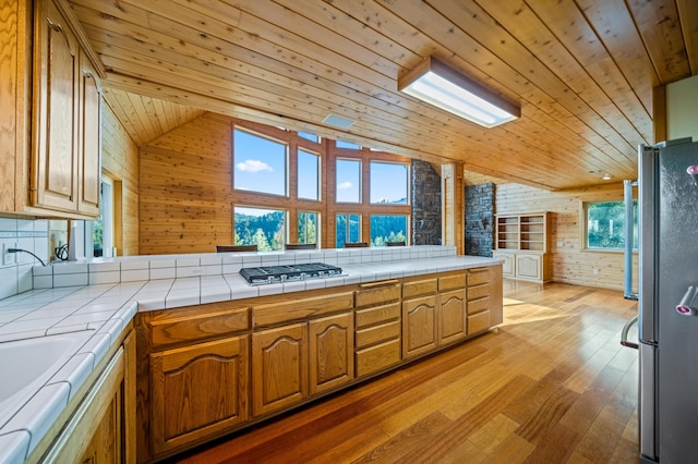 kitchen featuring tile countertops, wood ceiling, and appliances with stainless steel finishes