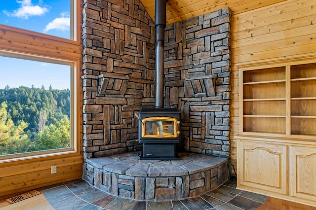 details with a wood stove and wooden walls