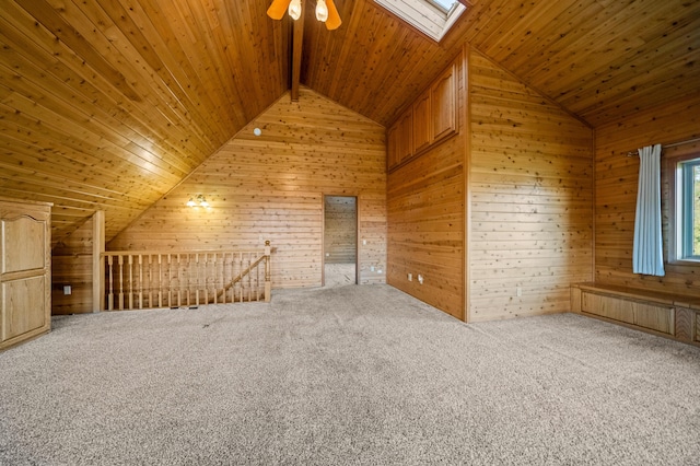 bonus room with carpet, a skylight, wood ceiling, ceiling fan, and high vaulted ceiling