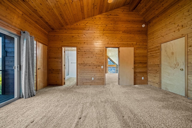 unfurnished room featuring carpet flooring, wooden walls, wood ceiling, and high vaulted ceiling