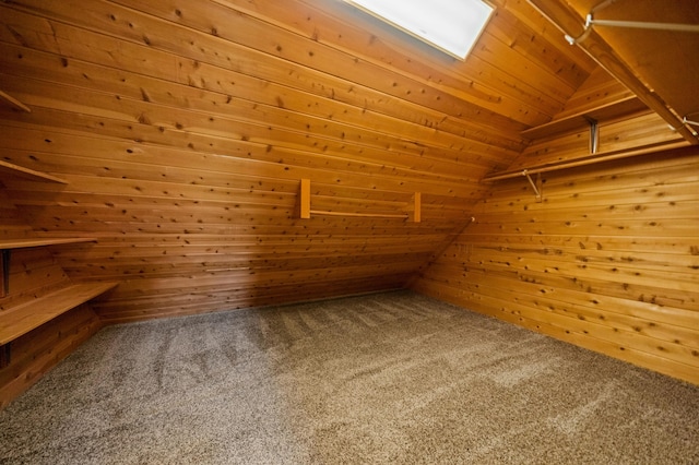 spacious closet with lofted ceiling and carpet floors