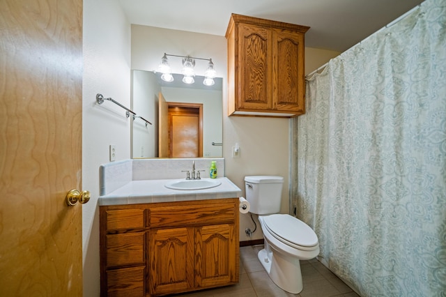 bathroom featuring tile patterned floors, vanity, and toilet