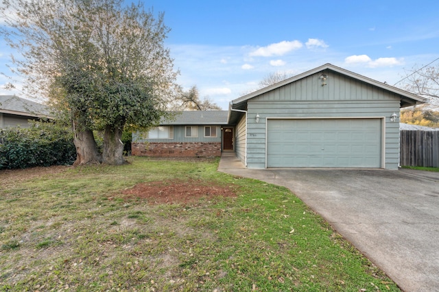 ranch-style house with a front yard and a garage