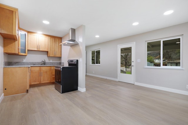 kitchen with wall chimney exhaust hood, sink, stainless steel range with electric cooktop, and light wood-type flooring