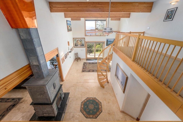 living room with beamed ceiling and a towering ceiling