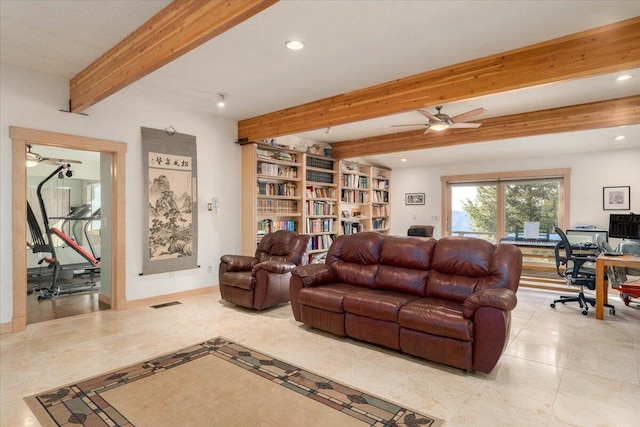 living room featuring ceiling fan, beam ceiling, and built in shelves