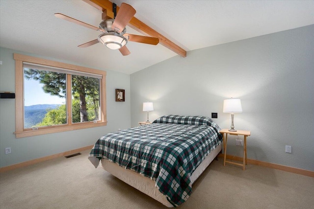 bedroom featuring ceiling fan, lofted ceiling with beams, and carpet floors