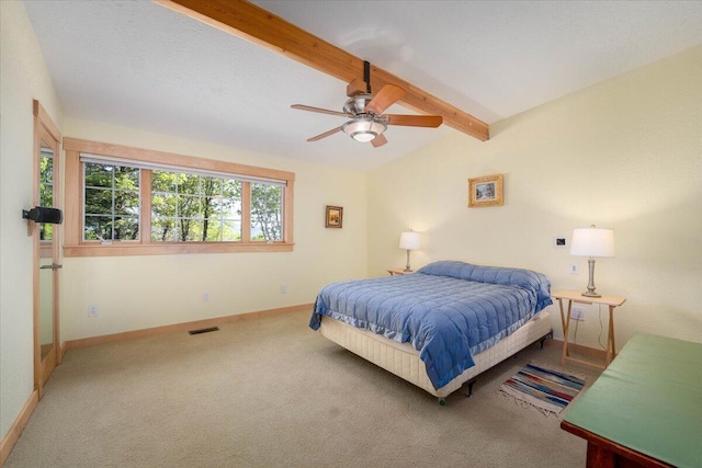 bedroom featuring vaulted ceiling with beams, ceiling fan, and carpet