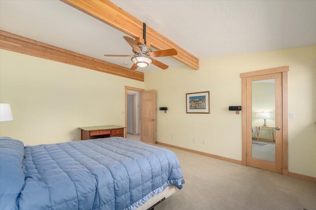 carpeted bedroom with beam ceiling and ceiling fan