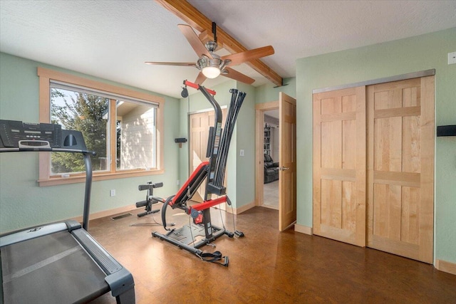 exercise room with ceiling fan