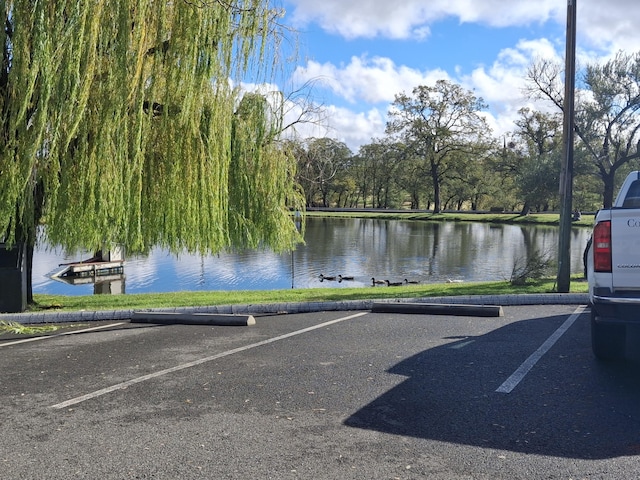 view of parking with a water view