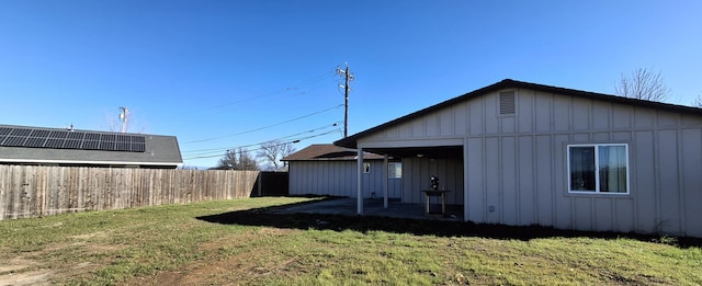 back of property featuring a lawn