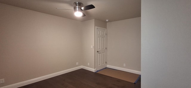 unfurnished room featuring dark wood-type flooring and ceiling fan