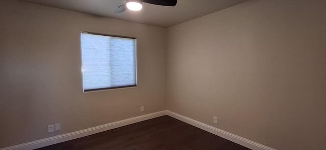 empty room with ceiling fan and dark hardwood / wood-style flooring