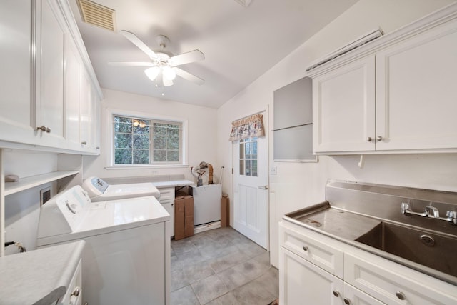 laundry area featuring sink, light tile patterned floors, ceiling fan, cabinets, and washing machine and clothes dryer