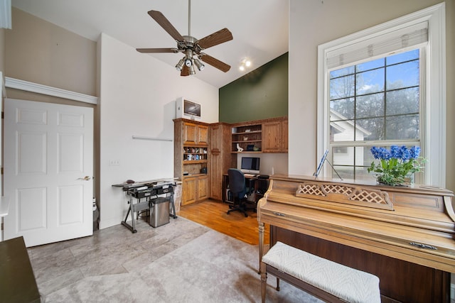 miscellaneous room with ceiling fan and high vaulted ceiling