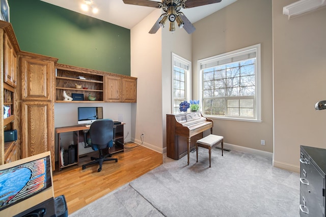 office area featuring ceiling fan and a towering ceiling