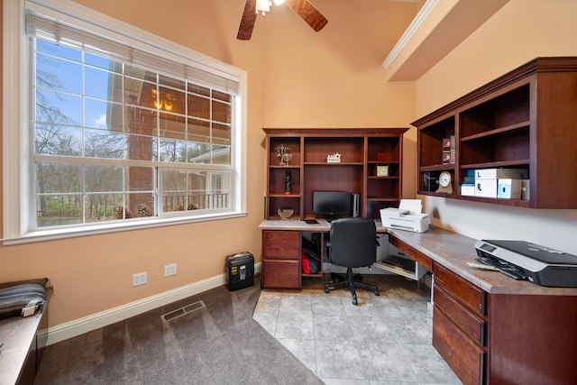 office featuring ornamental molding, built in desk, ceiling fan, and light tile patterned floors