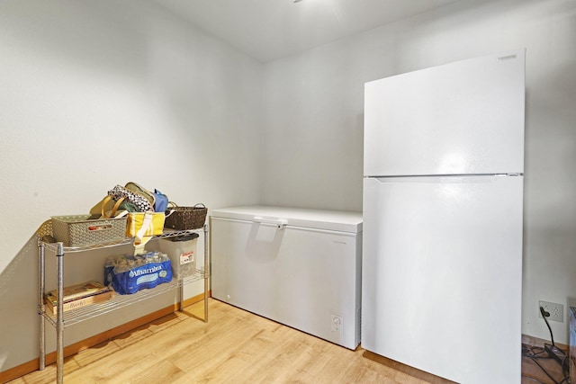 laundry room with light hardwood / wood-style flooring