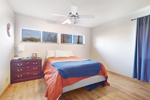 bedroom with ceiling fan and light wood-type flooring