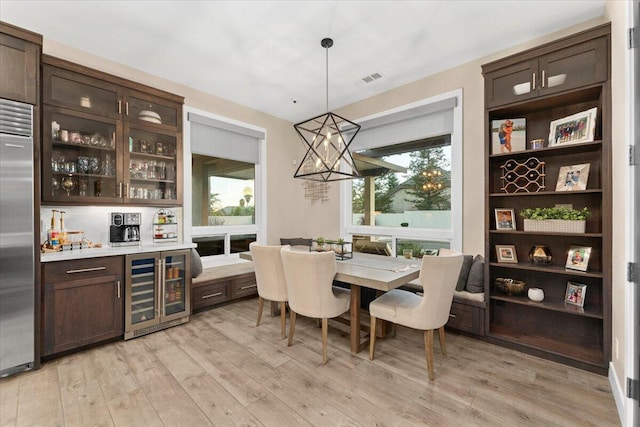 dining room featuring light hardwood / wood-style floors and beverage cooler