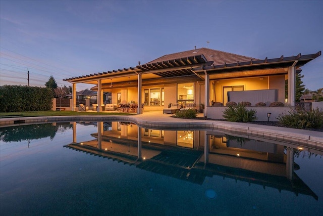 pool at dusk with a patio area