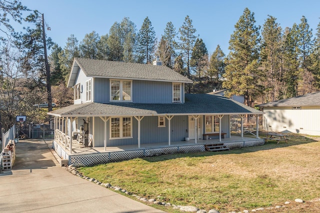 view of front of house featuring covered porch and a front lawn