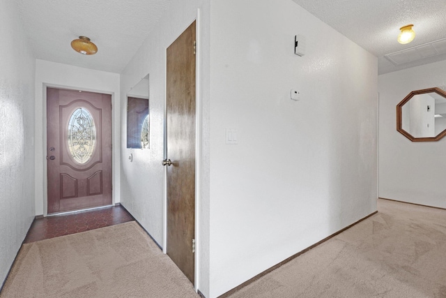 interior space featuring carpet floors and a textured ceiling