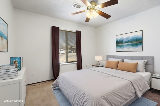 bedroom with light carpet and ceiling fan