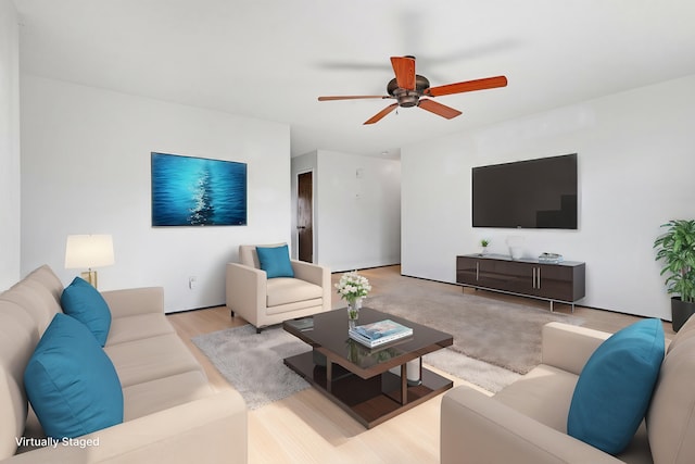 living room featuring ceiling fan and light hardwood / wood-style flooring