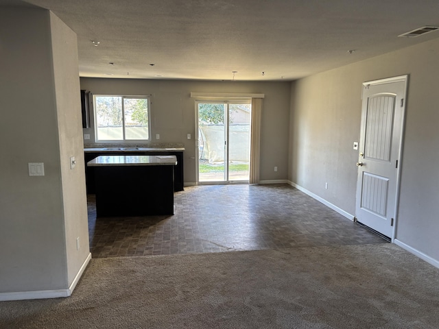 kitchen featuring dark colored carpet