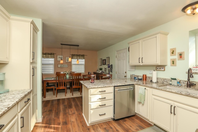 kitchen featuring dishwasher, hanging light fixtures, kitchen peninsula, dark hardwood / wood-style floors, and cream cabinets