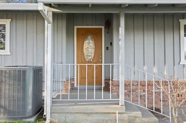 view of exterior entry featuring central air condition unit