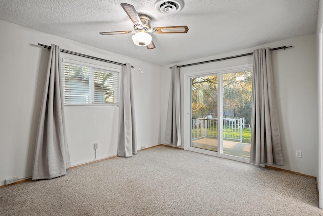 spare room featuring ceiling fan, a healthy amount of sunlight, and light colored carpet