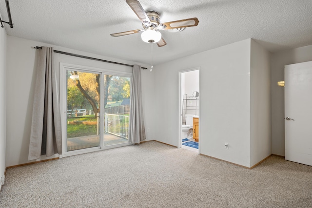 carpeted spare room with ceiling fan and a textured ceiling