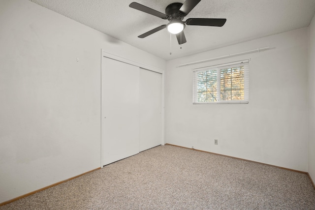 unfurnished bedroom with carpet flooring, a closet, ceiling fan, and a textured ceiling