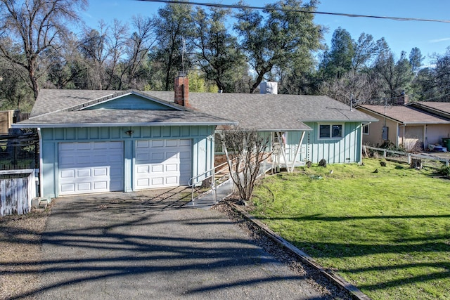 single story home featuring a front yard and a garage