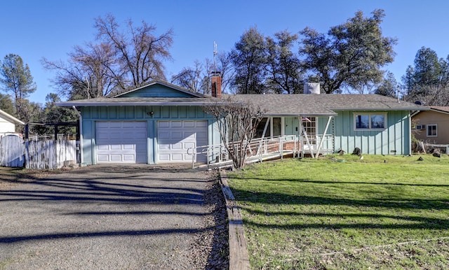 single story home with a front lawn, a garage, and covered porch