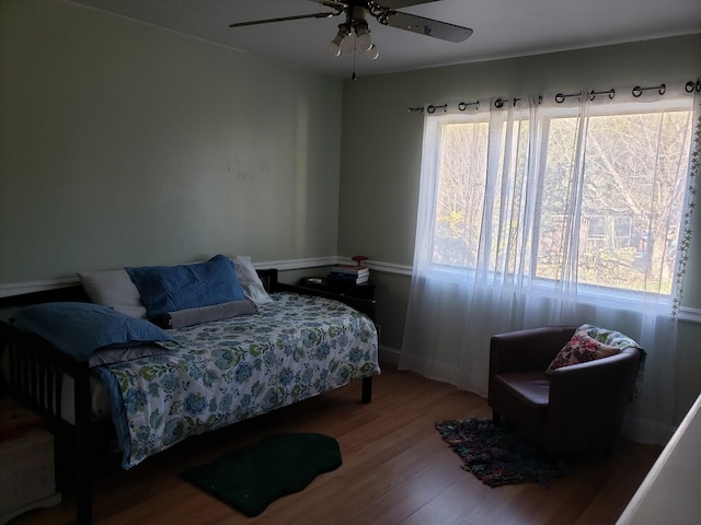 bedroom with wood-type flooring and ceiling fan