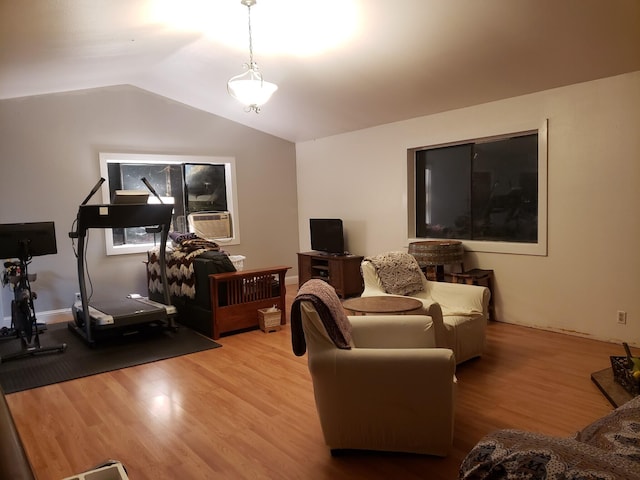 living room with hardwood / wood-style flooring, vaulted ceiling, and cooling unit