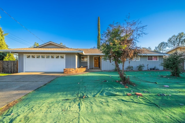 ranch-style house featuring a front lawn and a garage