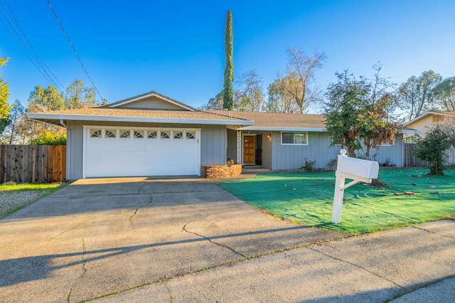 ranch-style house featuring a garage and a front lawn