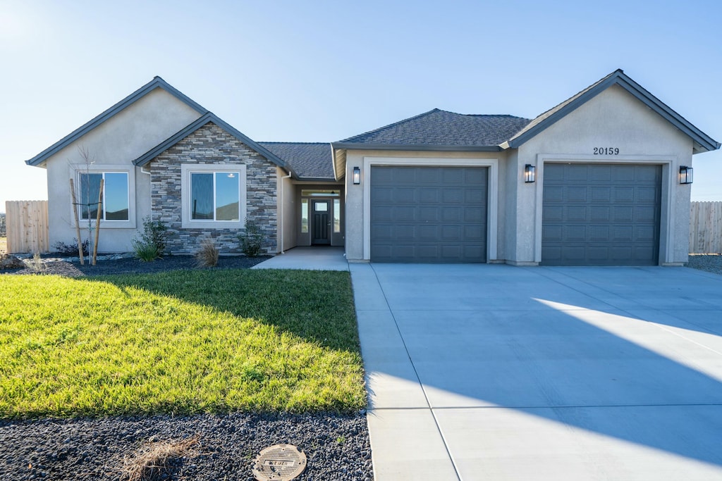 ranch-style house with a front lawn and a garage