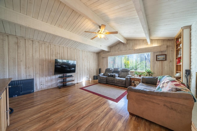 living room featuring ceiling fan, wooden walls, lofted ceiling with beams, and wood-type flooring