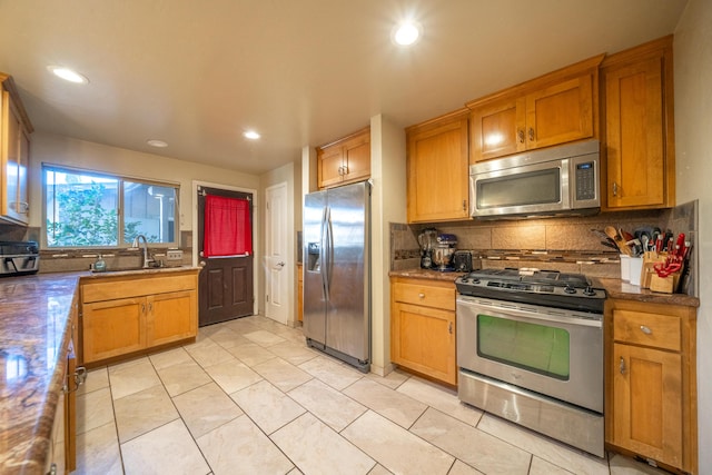 kitchen with brown cabinets, a sink, backsplash, recessed lighting, and stainless steel appliances