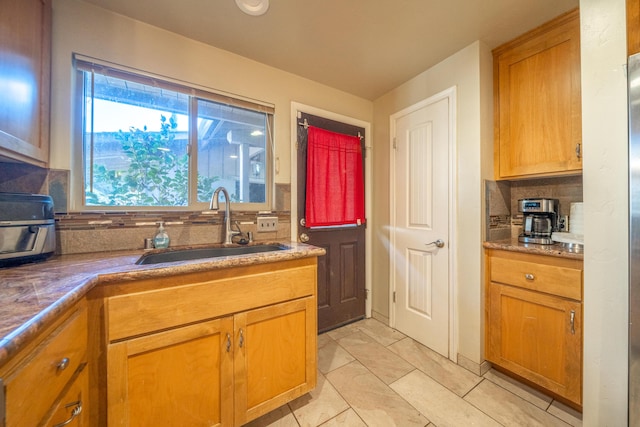 kitchen featuring sink and tasteful backsplash