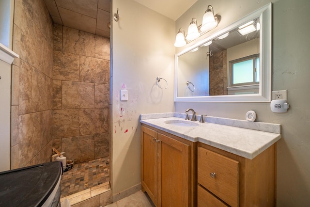 bathroom with vanity and tiled shower