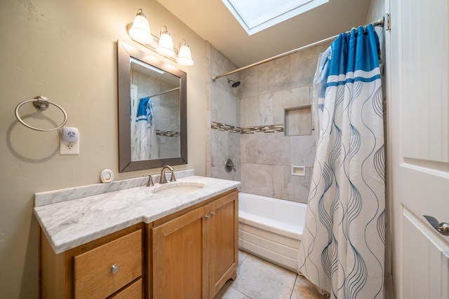 bathroom with tile patterned flooring, shower / tub combo with curtain, a skylight, and vanity