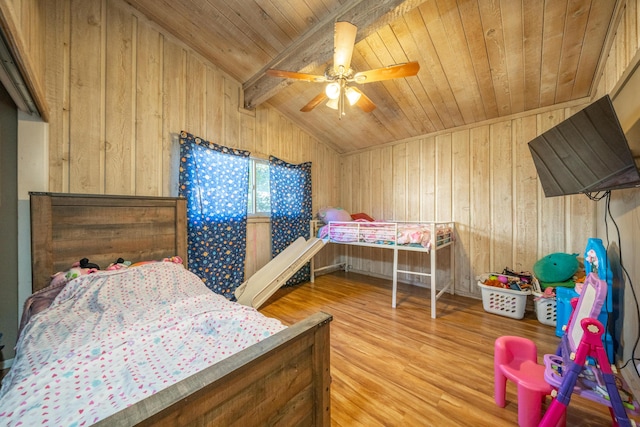 bedroom with wooden walls, wooden ceiling, vaulted ceiling with beams, and wood finished floors