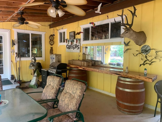 interior space with concrete floors and ceiling fan